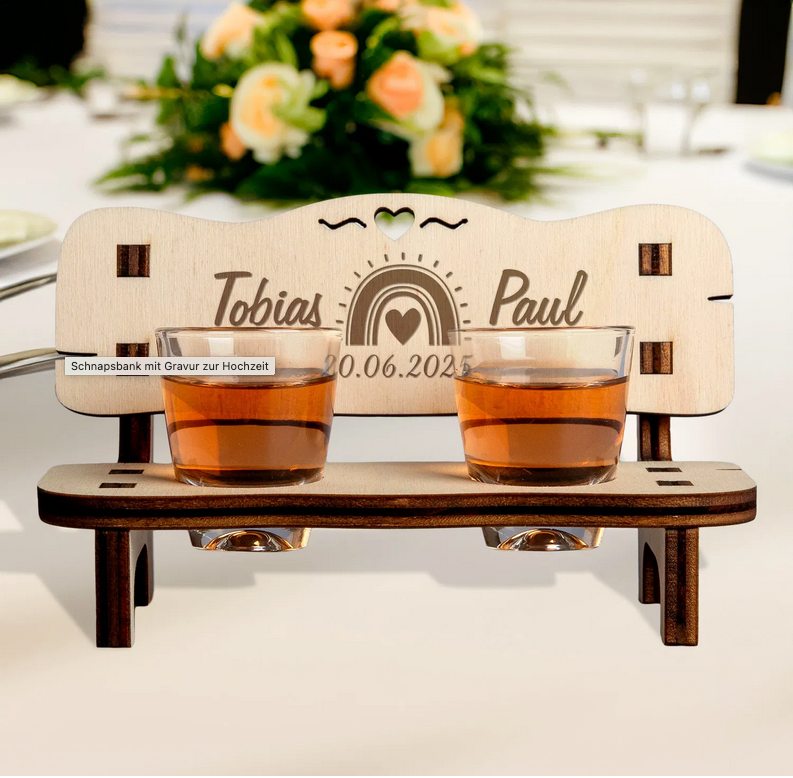 Charming personalized wedding gift - a wooden schnapps bench with engraved names and date, featuring two shot glasses and a heart cutout.